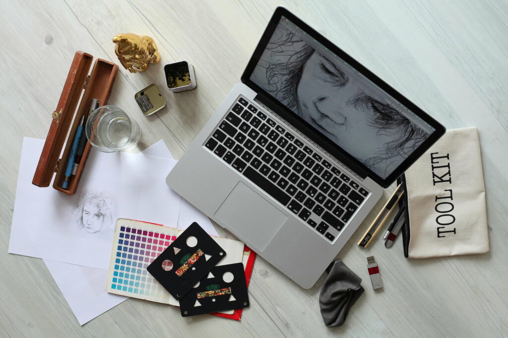 creative supplies and a laptop on a desk