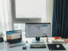 A job hunter’s guide to finding the right positions in Advertising & Marketing laptop on desk with a desktop on desk with some toys and a small plant